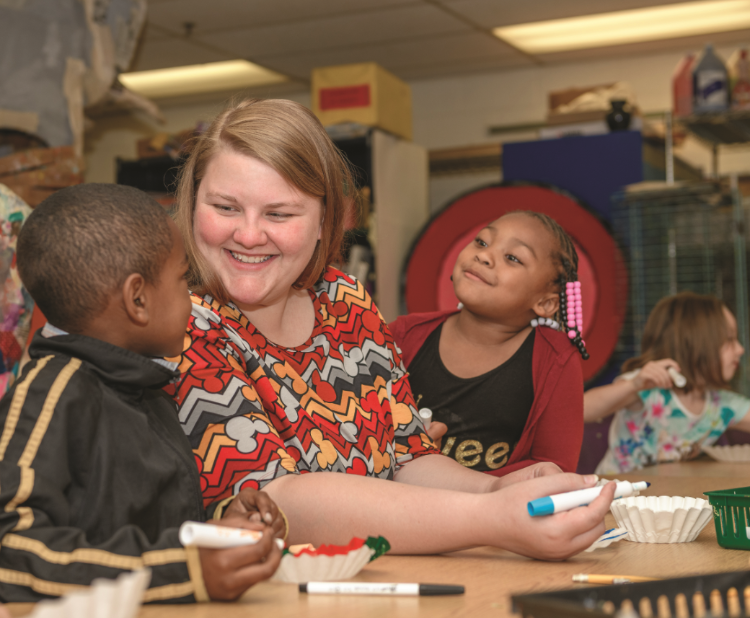 Brooke Eamigh ’16 works on a project with kindergarteners Jamarrious Eames (left) and Ceriah Williams at Prince Edward County Elementary School