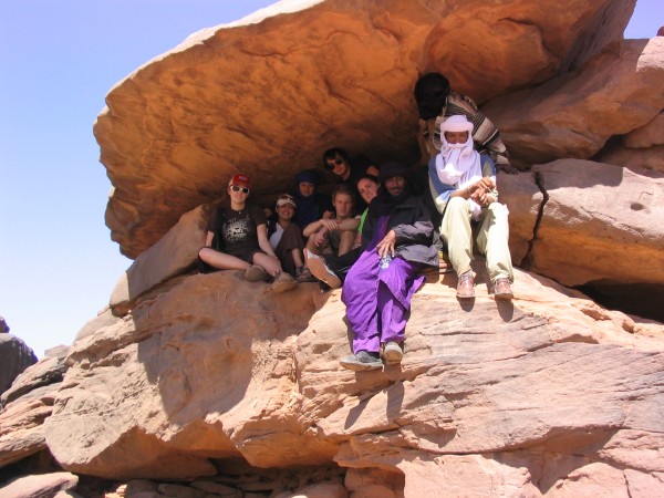 Longwood students pose on a rock in Niger with Dr. Steven Isaac