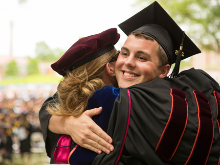 Graduating students hug at Longwood commencement