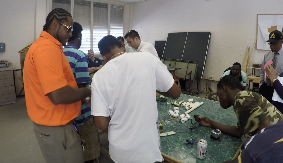 Then-Longwood student Garrett Josemans leads a class on wind turbines at a community college on the island of Grand Turk during a trip to the Caribbean with Dr. Chuck Ross.