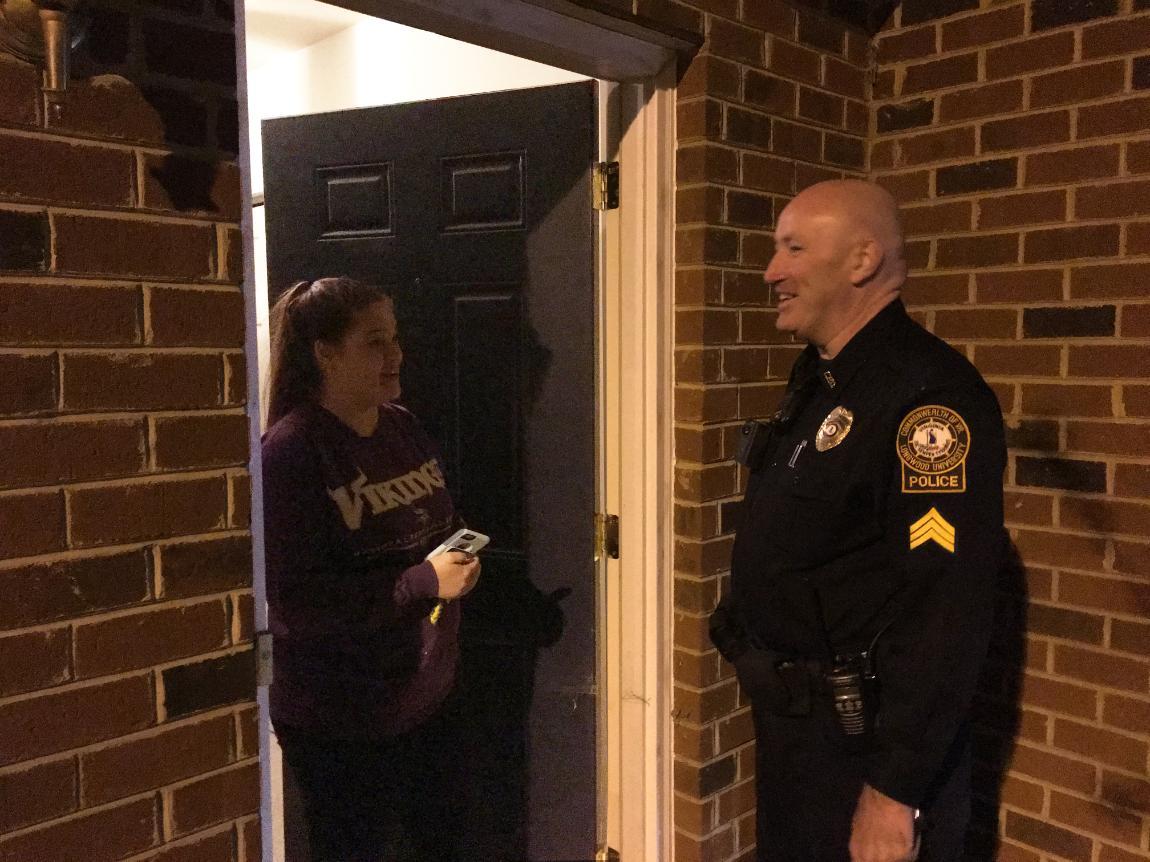 Sgt. Greg Giuriceo talks with Lindsey Kelly at Lancer Park after clearing her apartment the Thursday night of Spring Weekend.