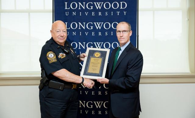 Longwood Police Chief Bob Beach accepts the award from Jerald W. Page, special agent in charge of the Secret Service’s Richmond Field Office