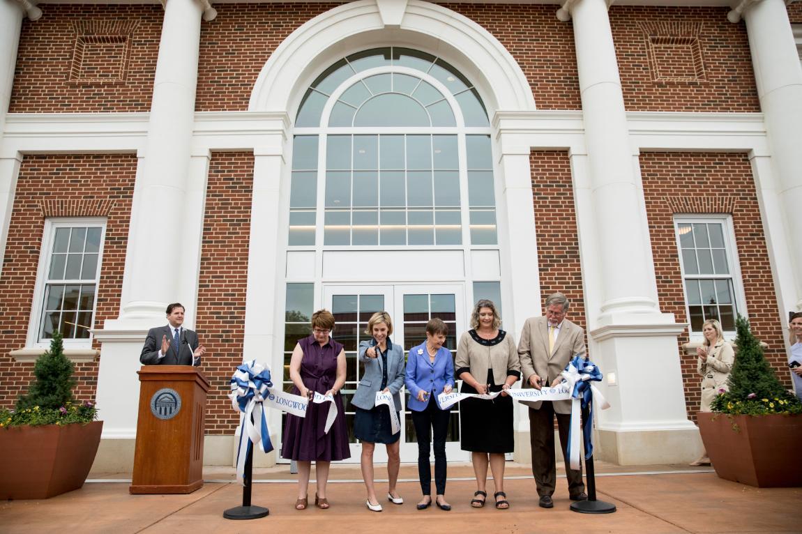 Joan Brock ’64 (center) was joined by her daughters, Kathryn and Christy (far left and second from left), as well as Dr. Jennifer Green (second from right), associate vice president for enrollment management and student success, and Project Manager Bob Chambers (far right) in cutting the ribbon to officially open Brock Hall.