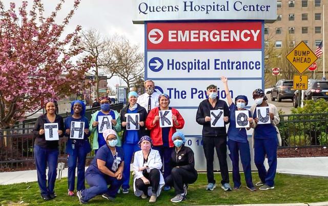 Kris Johnson '06 (holding the N) with some of her fellow nurses who traveled to New York City to aid in fighting the Covid-19 pandemic this spring. They are pictured in front of Queens Hospital Center with their bus driver, who drove them back and forth from their hotel to the hospital for their shift each day.