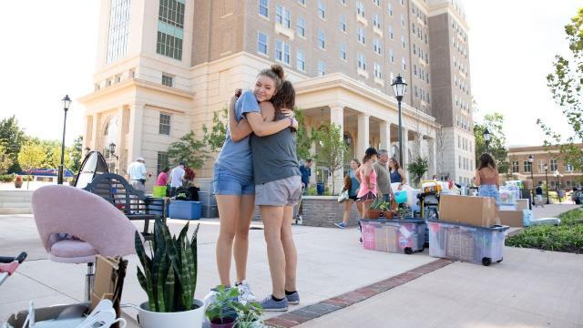 New student and sister hugging during move-in