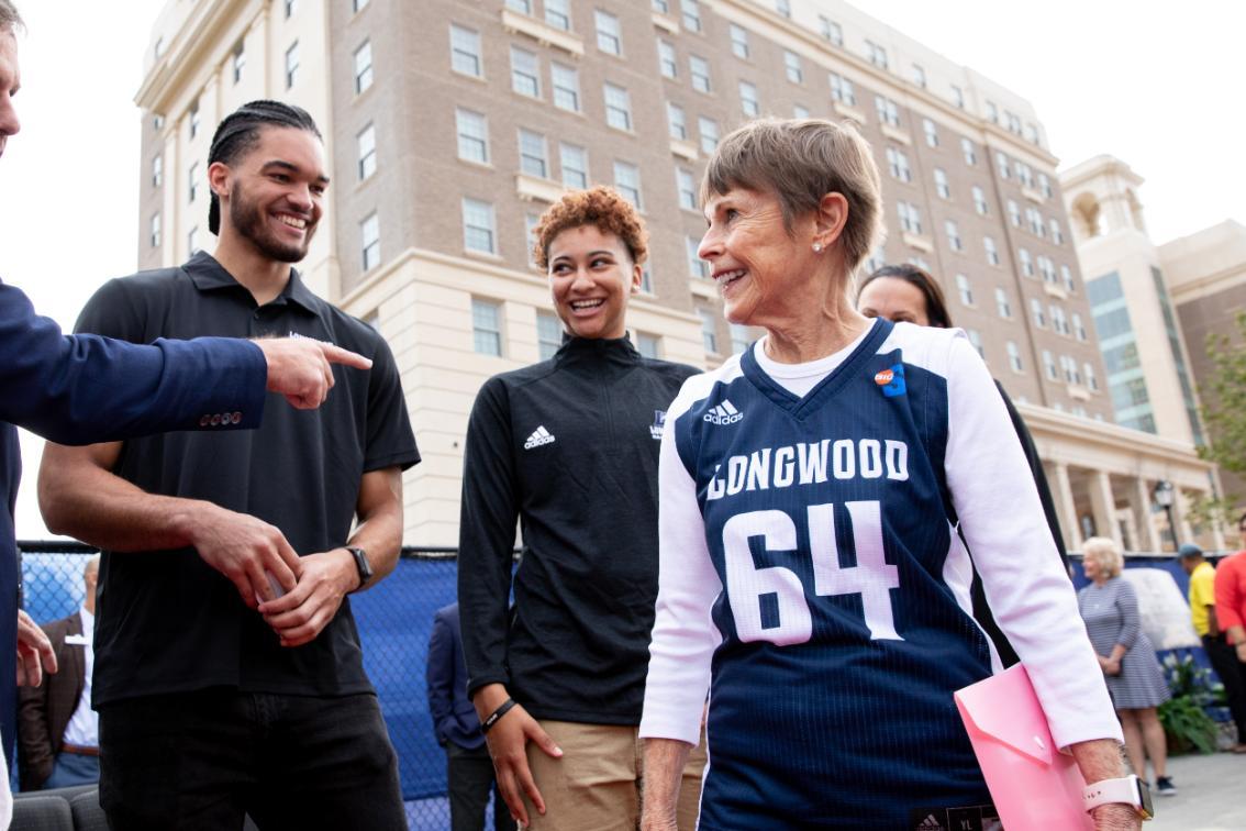 Joan Perry Brock '64 wearing a basketball jersey with her name and the number 64